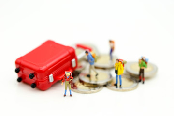 Miniature concept : Group of young traveler traveling / standing on coin Currency of the world,business trip traveler concept.
