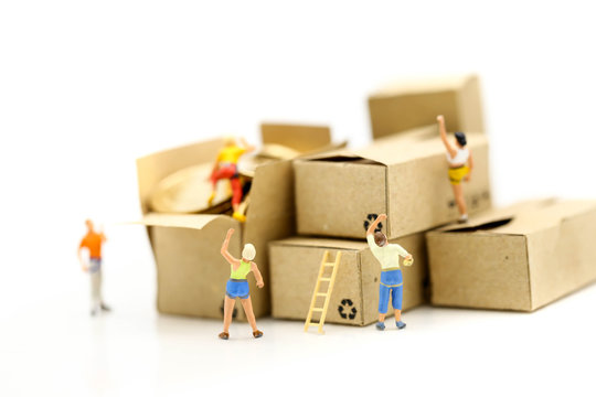 Miniature people : climbers team climbing on box of coins,Business travel concept.