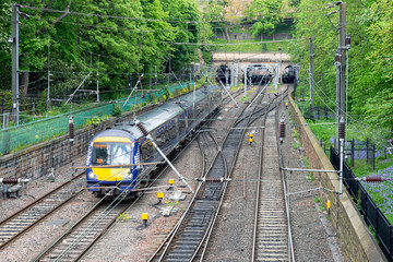 Train approaching Waverley station through Princes Street Gardens in Edinburgh, Scotland