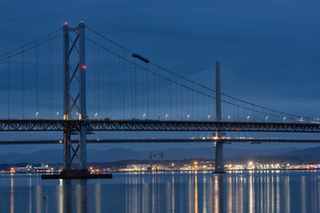 Naklejka na ściany i meble Evening view at Forth Road Bridge and Queensferry Crossing over Firth of Forth near Queensferry in Scotland