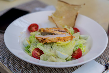 Caesar Salad with grilled chicken on a plate.