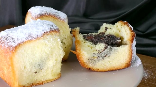 Buchty - Czech traditional sweet dessert sprinkled with powder sugar usually filled with poppy seeds, special jam (called povidla) or quark. Eating.
