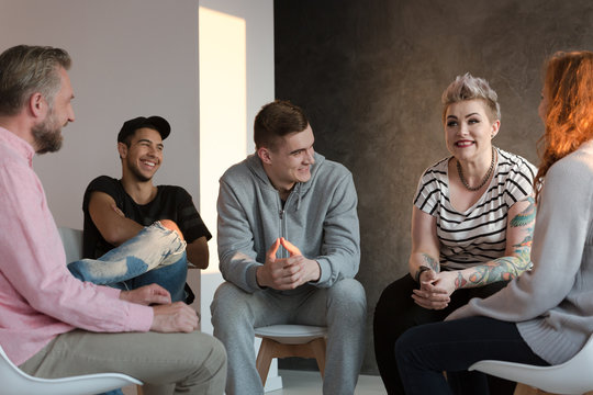 Teenagers laughing during a group counseling session for youth