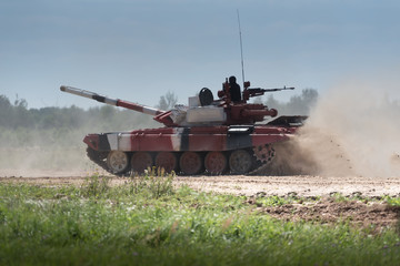 Military or army tank ready to attack and moving over a deserted battle field terrain. a lot of...