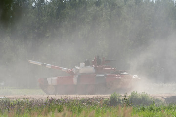 Military or army tank ready to attack and moving over a deserted battle field terrain. a lot of...