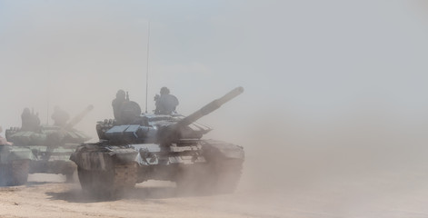 Military or army tank ready to attack and moving over a deserted battle field terrain. a lot of...