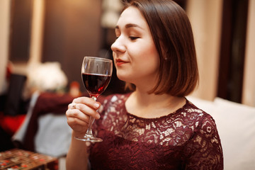 Portrait of a gorgeous young brunette woman having wine fun.