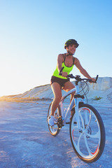 Fototapeta premium Young sporty woman with a bike, soft focus background