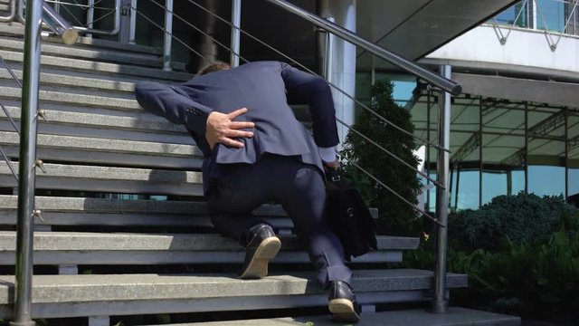 Office manager suffering back pain, spinal disorder, compressed nerve roots