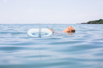 Beautiful young surfer female in sexy pink bikini with single fin surf longboard. Girl have fun...