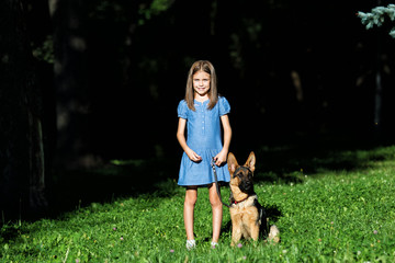 little girl and a puppy on a walk