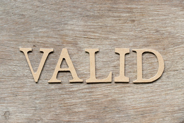 Alphabet letter in word valid on wood background
