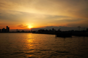 New York City skyline with urban skyscrapers over Hudson River. Manhattan panorama from Chelsea district. Pier waterfront view to the harbor at sunset.

