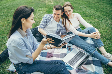 Group of students preparing for the seminar sitting on the lawn