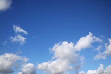 Naklejka na ściany i meble White clouds on a blue sky on a sunny day