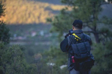 guy taking photos from a mountain