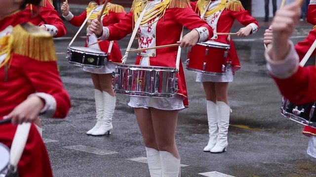 Majorets are lined and knocking out the melody. Street performance on the occasion of the holiday. Rainy day