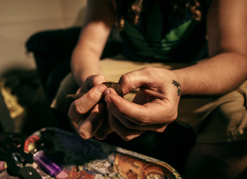 A Man Rolling A Blunt