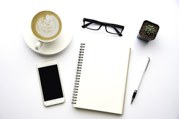 Top view with copy space, working desk with laptop,cell phone,notebook pencil and coffee on white background
