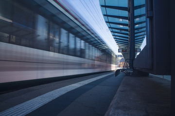 Moving tram train driving through a train station moving public transport