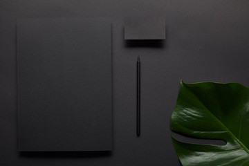 flat lay with Business mock up with black notebook and card on black background