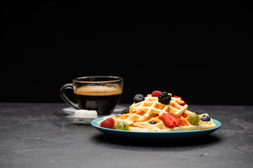 Photo of cup of coffee with Belgian wafers with strawberries, raspberries