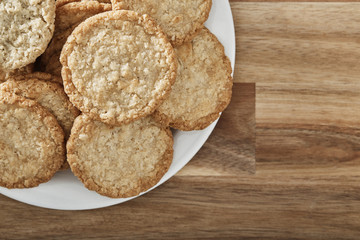 cookies on white plate and wooden background. Top view.