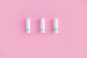 Menstrual tampon  on a pink background. Menstruation time. Hygiene and protection. Pasterl colors.
