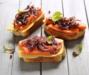 Bruschetta with roasted pumpkin, cheese and fried onions