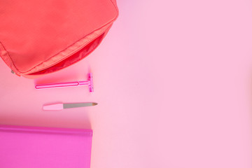 Pink women's razor on a pink background