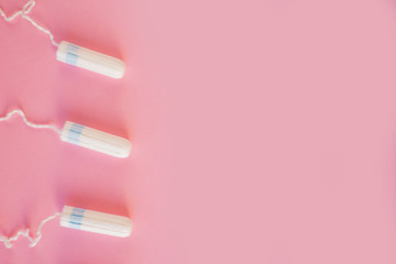 Menstrual tampon  on a pink background. Menstruation time. Hygiene and protection. Pasterl colors.
