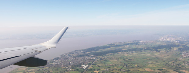 Aerial View of Bristol City Center in England, UK  and surrounding fields. On the left the airplane wing.