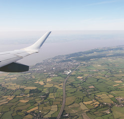 Aerial View of Bristol City Center in England, UK  and surrounding fields. On the left the airplane wing.