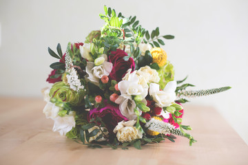 Nice bridal bouquet with garden roses, carnations, freesias and greenery