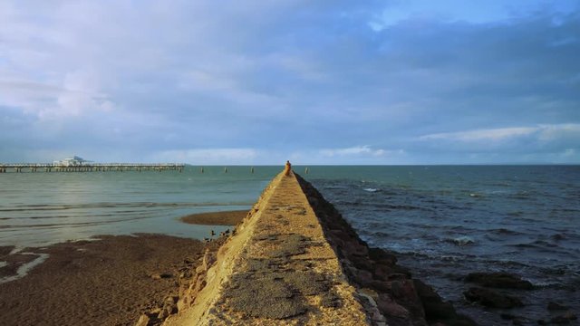 Walking to the end of the rockwall near Shorncliffe pier in Brisbane, Australia