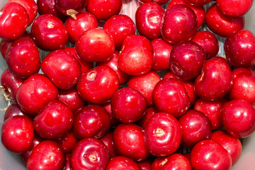 Fresh and juicy cherries just collected in the garden on a grey stone
