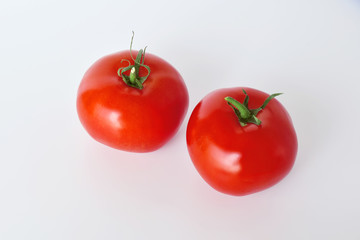 Tomato, or tomato (Latin Solánum lycopérsicum) - annual or perennial herbaceous plant, species of the genus Pasleum (Solanum) on a white background isolated