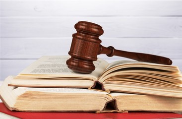 Books and wooden gavel on table. Justice