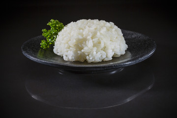 Japanese traditional steamed white rice, steamed rice on black background, Japanese food, Japanese dish