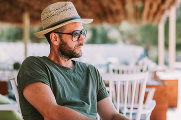 Young man sitting in a beach bar