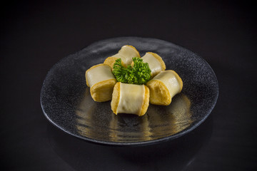 Sukiyaki Asian food, fried fish ball on black background, Japanese traditional food
