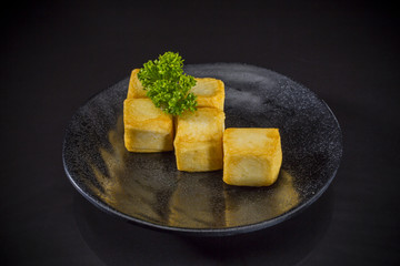 Asian food, fried fish tofu on black background, Japanese traditional food