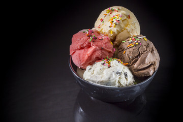 Various ice cream scoops, Ice cream scoops in sundae cup, Mixed ice cream in ice cream cup on black background