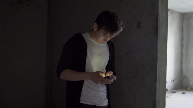 Young drug addict pushes the phone in a bad state of health