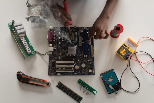 Girl soldering a circuit board at desk