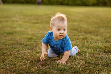 Baby first year life fun crawling on the grass.