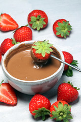 Fondue with Melting chocolate or melted chocolate and strawberry.