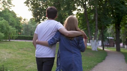 Young couple walk at the park