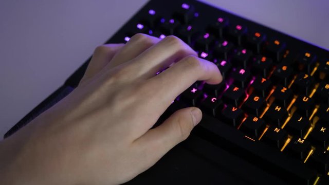 Man Playing Computer Game on RGB Keyboard Left Hand Close Up 