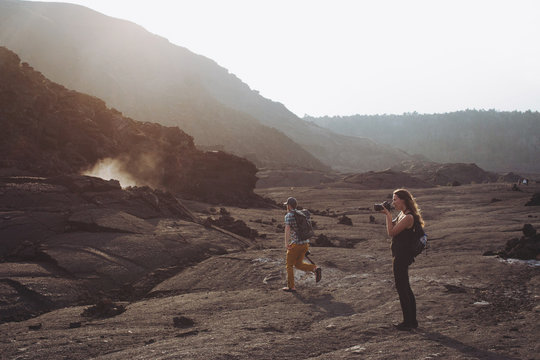 People exploring volcanic area